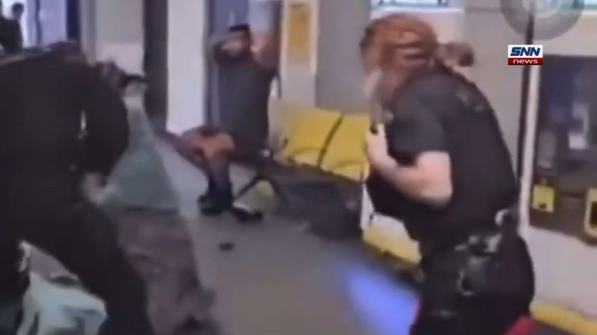 British police officers allegedly assaulting a restrained Muslim man while his wife watches, raising human rights concerns.