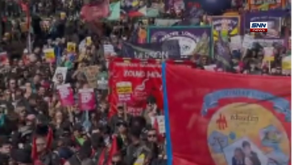 Tens of thousands of protesters marching in London with banners promoting unity, equality, and human rights during an anti–far right demonstration.