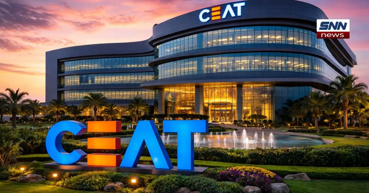 Modern CEAT headquarters building at sunset with illuminated glass facade, landscaped garden, fountain, and large CEAT logo in foreground.