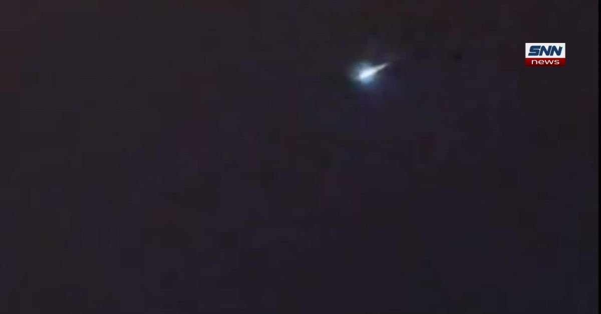 Kyiv night sky with bright burning object during fifth year of war as residents fear missile attack.