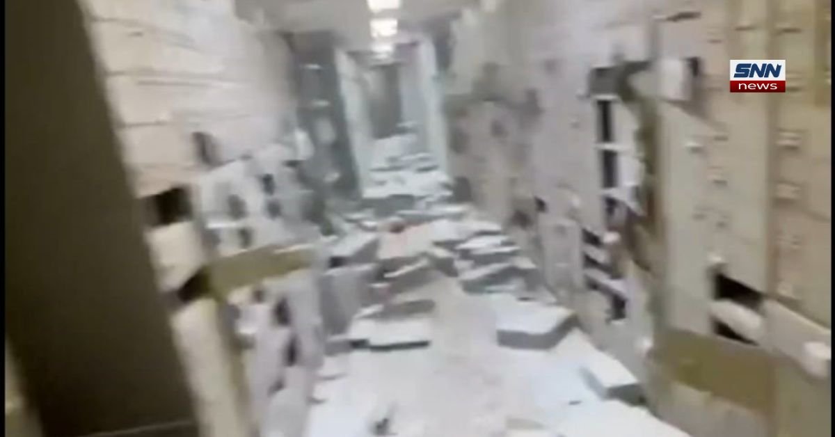 Police outside Naples bank after armed robbers took hostages and escaped through underground tunnel in Italy.