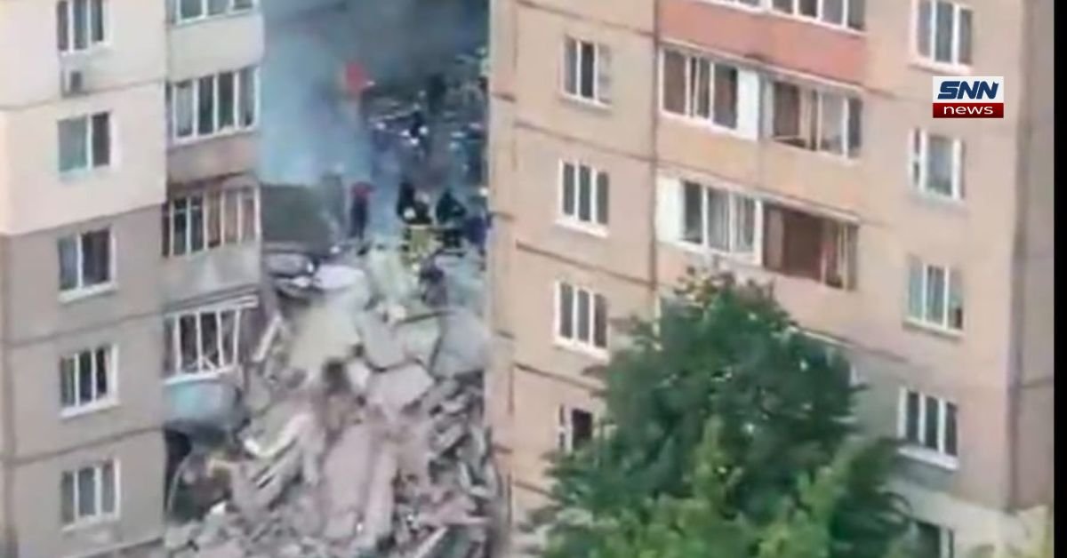 Damaged residential building in Kyiv after a deadly missile strike as emergency teams search through debris.