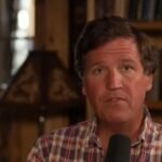 Tucker Carlson speaking during a broadcast discussing allegations about classified documents linked to the Rwandan genocide.