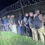 Ukraine border guards patrol a remote crossing area near Romania as authorities detain men attempting to flee wartime mobilization.