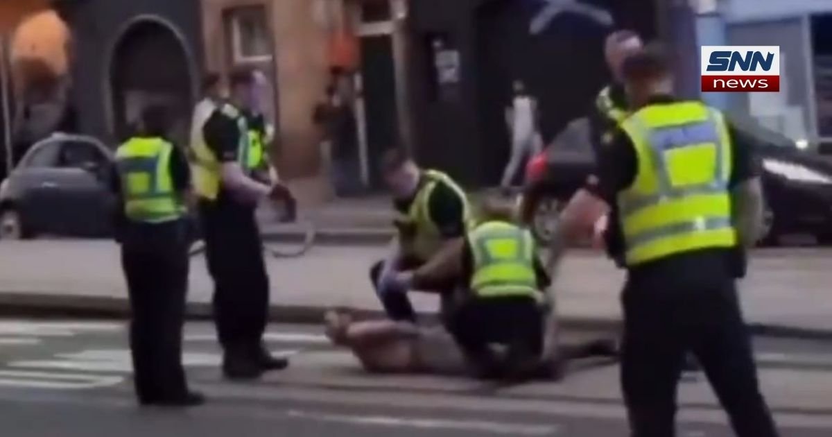 Police cordon outside a mosque in Scotland following a knife and axe attack that left five people injured and one suspect detained