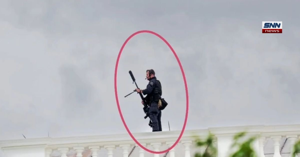 US Secret Service counter-sniper agent carrying rifle during President Donald Trump protection detail at public event 2026
