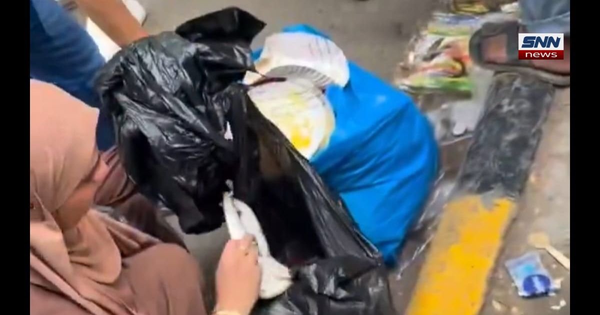 Hijab-wearing woman cleaning up litter at CJP protest in Jantar Mantar