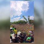 A large crowd of supporters in yellow and green Brazil jerseys at a political rally, SNN News Finland