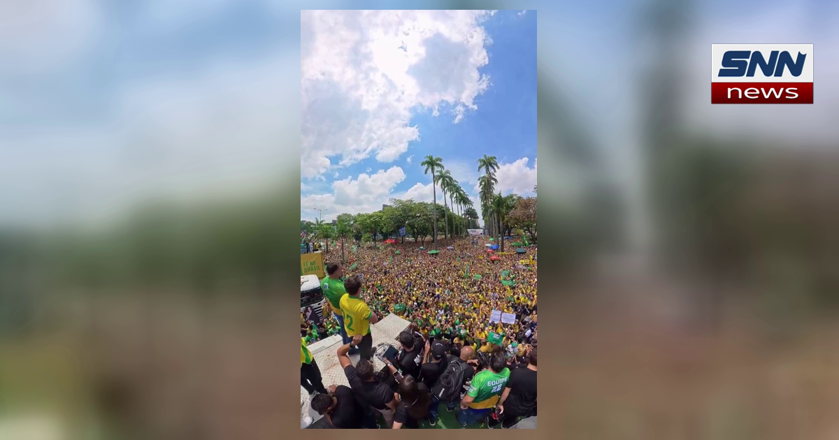 A large crowd of supporters in yellow and green Brazil jerseys at a political rally, SNN News Finland